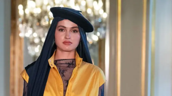 A model walks the runway wearing a headscarf and beret during the Paris Modest Fashion Weeks 2026 by Think Fashion at Hotel Le Marois on April 16, 2026 in Paris, France